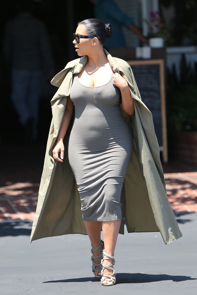 Kim stuck to her signature silhouette — a body-hugging tank dress and duster coat, this time in shades of tan and gray.