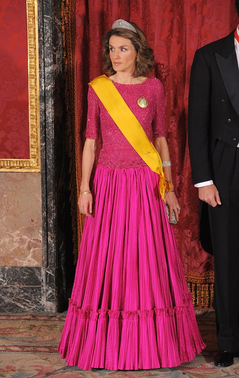 Wearing a Three-Quarter-Sleeved Shimmery Bodice and Pleated Fuchsia Gown