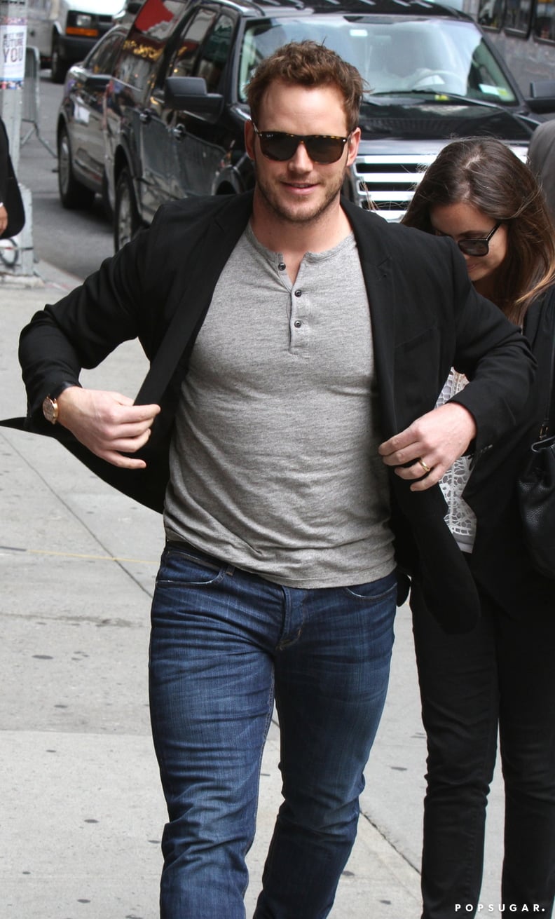 Chris Pratt's trying desperately to button his jacket with little to no success.