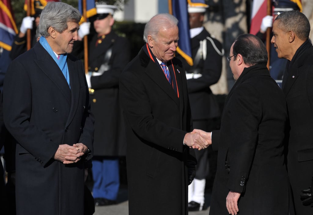 Joe Biden and John Kerry welcomed the French president with handshakes.