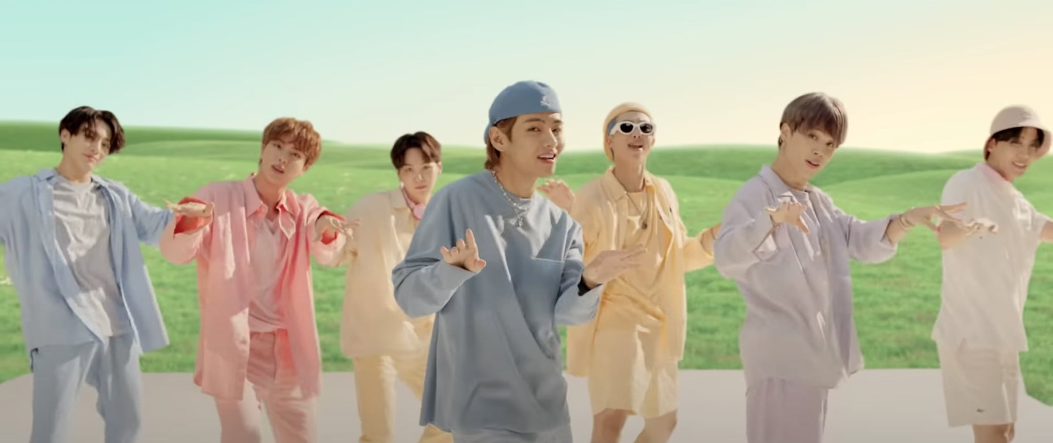The group wears an array of pastel-colored outfits, including matching Kangol hats!