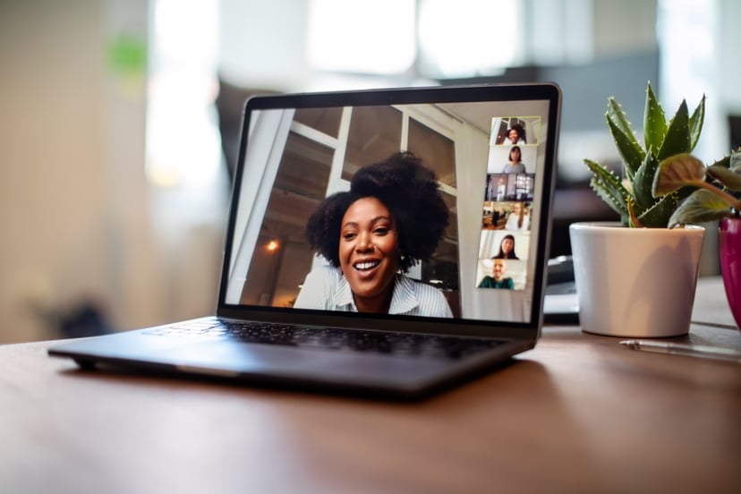 Shot of african businesswoman having a video call on a laptop with her team. Woman having meeting on video call on laptop with diverse colleagues,