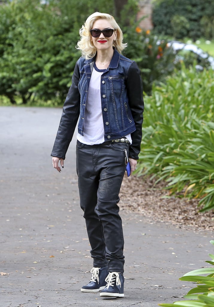 Gwen Stefani was slick in a leather-sleeved denim jacket by Paige Premium Denim, matching black leather baggy jeans, a baseball tee, and high-top sneakers.