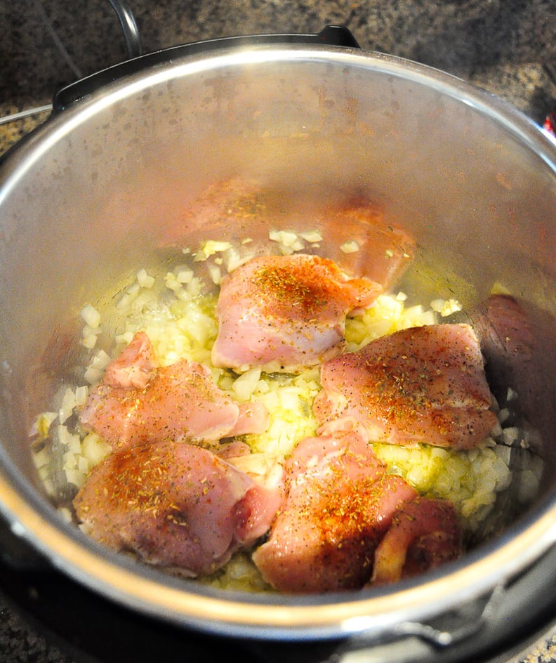 Brown the onions, garlic, and chicken thighs.