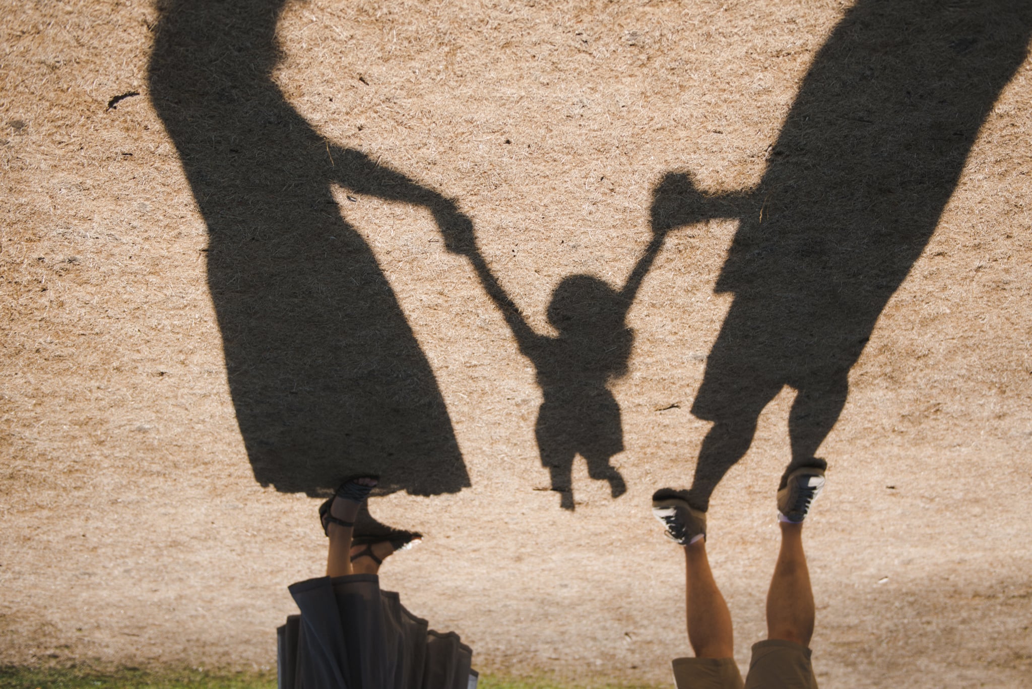 Happy Moments Outdoors. Shadow Of Family  During Sunny Day