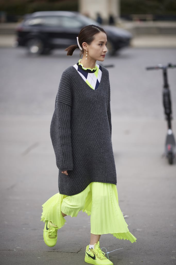 Dress down a feminine skirt with an oversize sweater and high-tops.