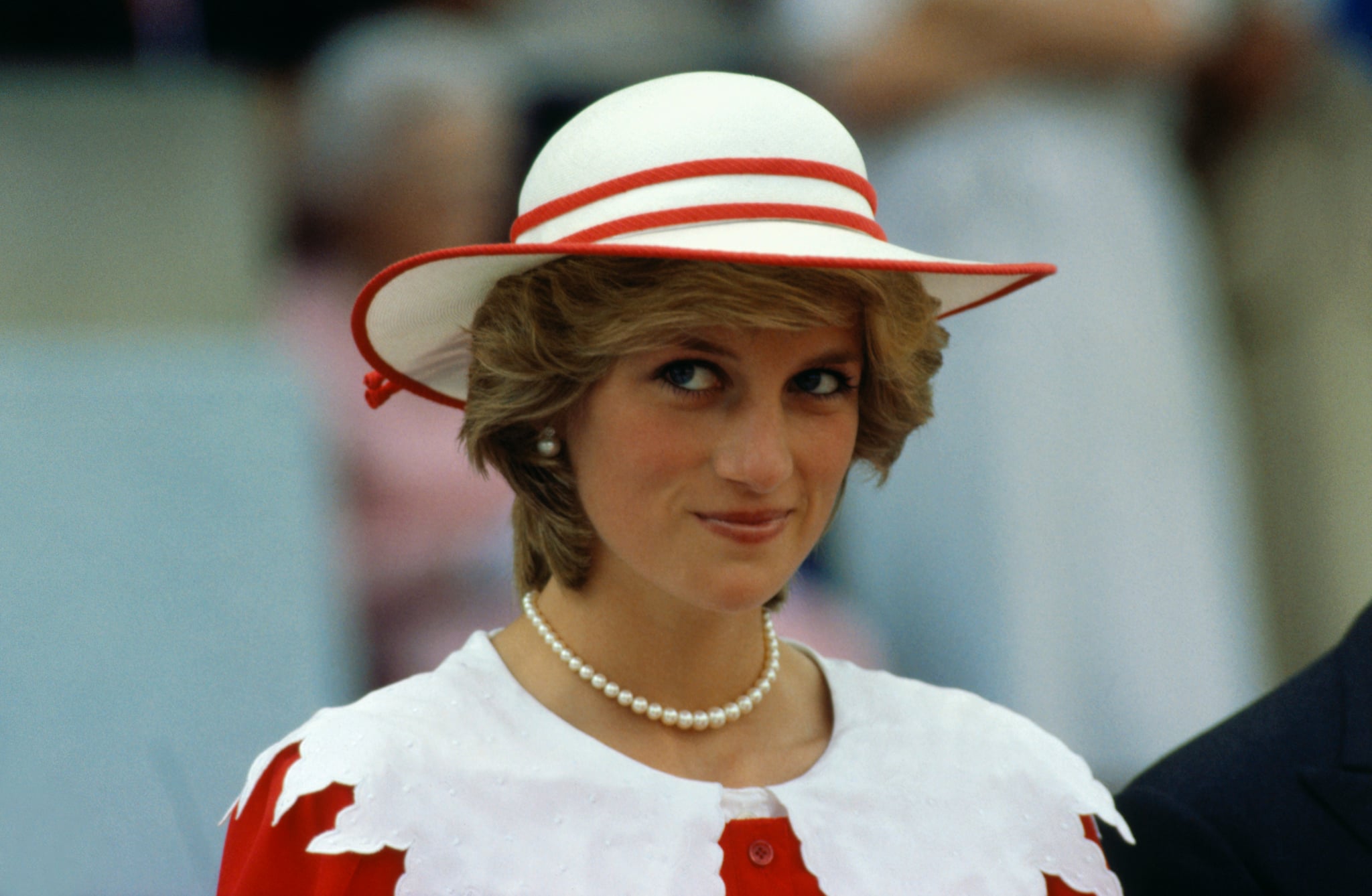 Diana, Princess of Wales, wears an outfit in the colours of Canada during a state visit to Edmonton, Alberta, with her husband.