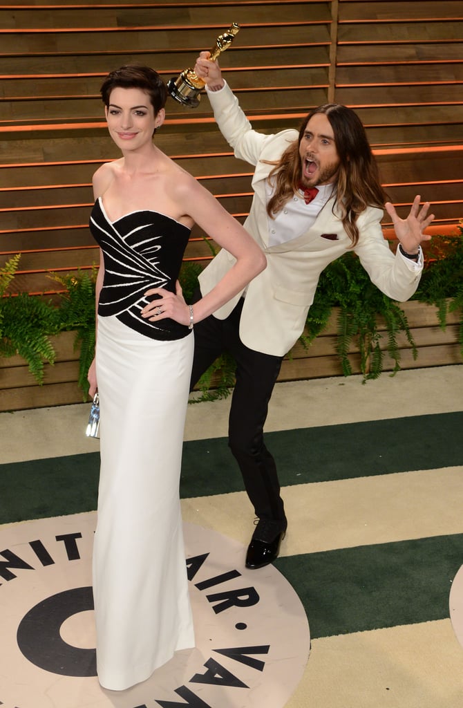 The fun photobombs continued after the Oscars, when Jared Leto snuck up behind Anne Hathaway on his way into the Vanity Fair bash.