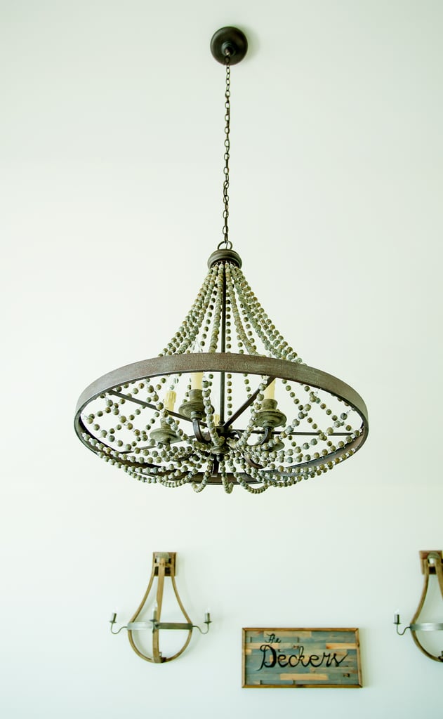 Jessie's favorite pieces of new decor are the statement-making chandeliers, like this one in the living room. "They were a big must for us here — they bring a big hit of sophistication to the beach and really finish off each room."