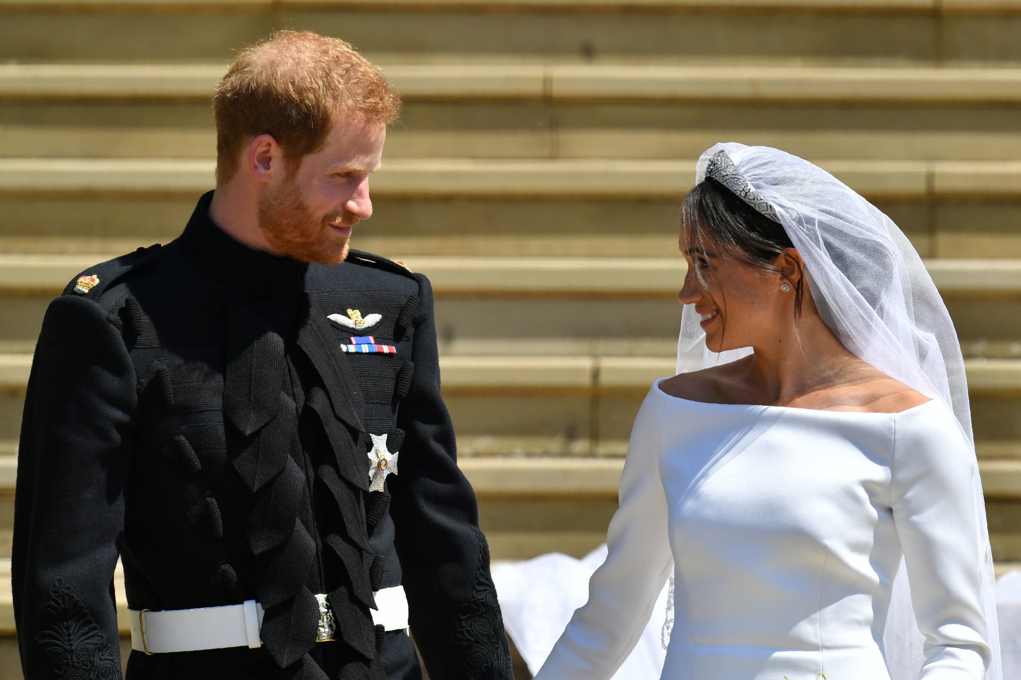 TOPSHOT - Britain's Prince Harry, Duke of Sussex and his wife Meghan, Duchess of Sussex leave from the West Door of St George's Chapel, Windsor Castle, in Windsor, on May 19, 2018 after their wedding ceremony. (Photo by Ben Birchall / POOL / AFP)        (Photo credit should read BEN BIRCHALL/AFP/Getty Images)