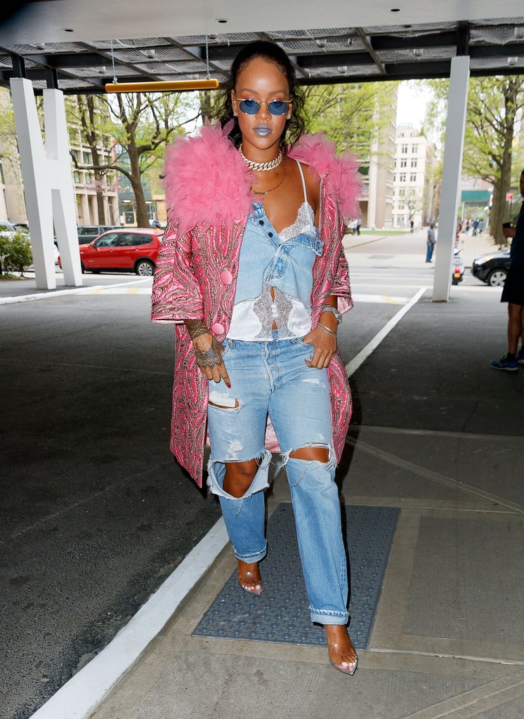We love how Rihanna styled her half-unbuttoned denim skirt over her Savage x Fenty lingerie tank with a pink Marc Jacobs coat, a mini Fendi Peekaboo bag, and a new Savagex necklace.