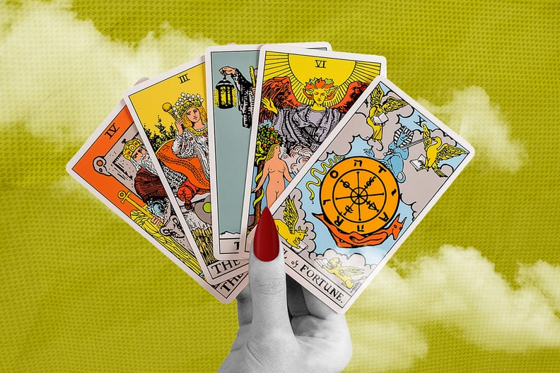 A hand holds a deck of Tarot cards.