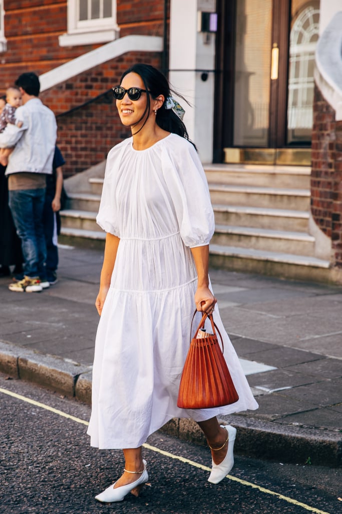 Style a simple parachute dress with a silk bow in your hair and leather glove pumps.