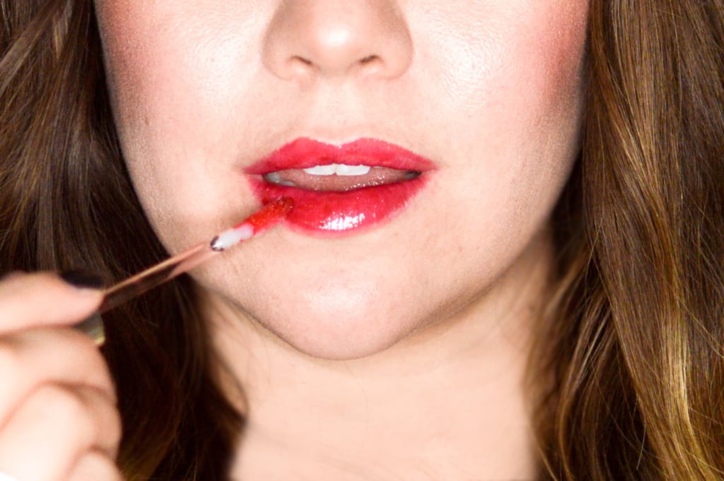 Start by applying a lip scrub or mask all over lips — this will eliminate any dry skin and also create a smooth canvas. I like Kaplan MD Lip 20 Mask ($48).
  
Once lips are smooth and set, apply a layer of liquid lipstick. Choose a shade that matches the glitter you'll be using. Since I'm using red, I chose Lorac Pro Liquid Lipstick in Berry Red ($19). Swipe the gloss generously all over lips.
