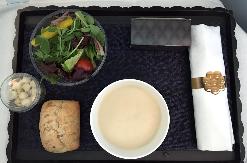 Soon after you take off, the flight attendants come by to take your order for your three-course meal. I chose the cauliflower cream soup as my first course, which came with a salad and bread. Prepared by "top Dutch chefs," it was actually really delicious. The salad was a perfect touch, considering some airlines offer more greasy foods for long flights.