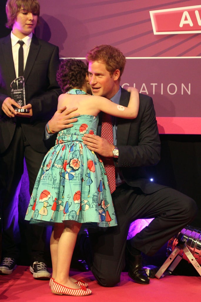 Harry hugged a young girl at the WellChild Awards at London's Intercontinental Hotel in 2012.