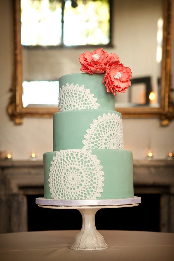 Pairing citrus-colored flowers against this mint-and-white cake is pretty genius (and ultrafeminine) if you ask us.  
Photo by Laura Ashbrook Photography via Style Me Pretty