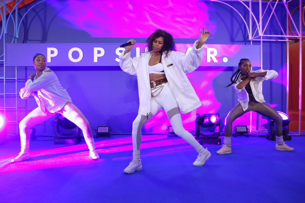 Aluna performed in white athleisure and a thick leopard belt.