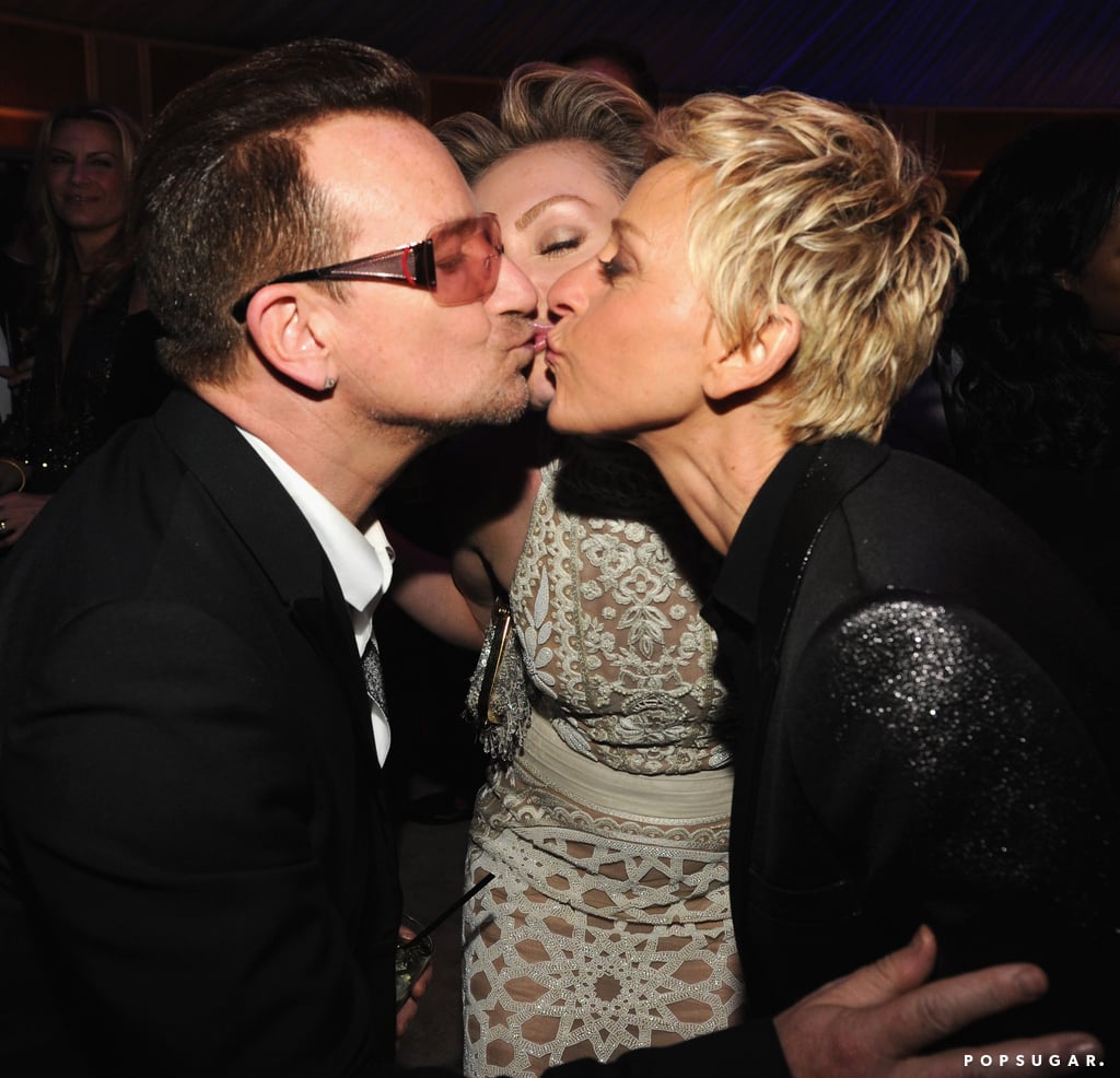 Ellen DeGeneres and Portia de Rossi went in for a three-way kiss with Bono at the Vanity Fair bash.