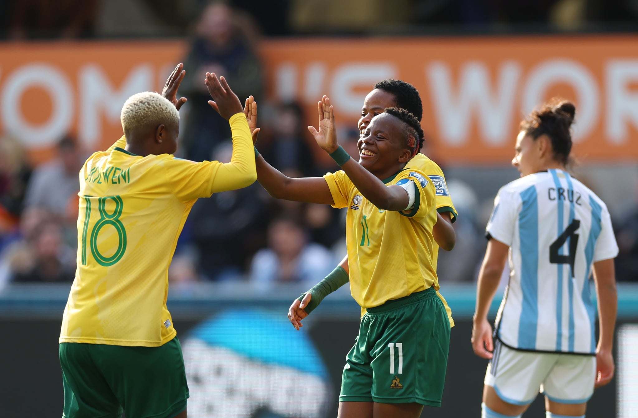 DUNEDIN, NEW ZEALAND - JULY 28: Thembi Kgatlana (2nd L) of South Africa celebrates with teammate Sibulele Holweni (1st L) after scoring her team's second goal during the FIFA Women's World Cup Australia & New Zealand 2023 Group G match between Argentina and South Africa at Dunedin Stadium on July 28, 2023 in Dunedin, New Zealand. (Photo by Lars Baron/Getty Images)