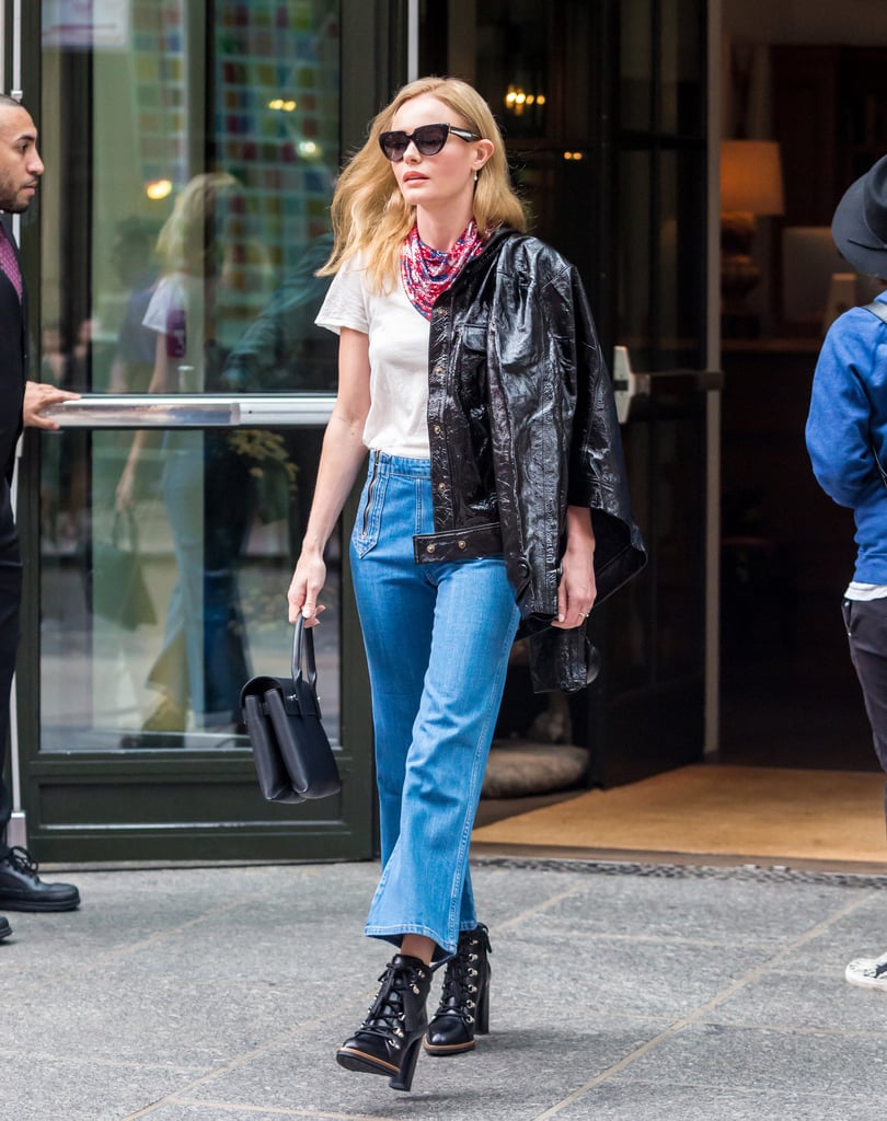 Kate worked a slick leather jacket on one shoulder, completing her outfit with lace-up booties and a silk neck scarf.