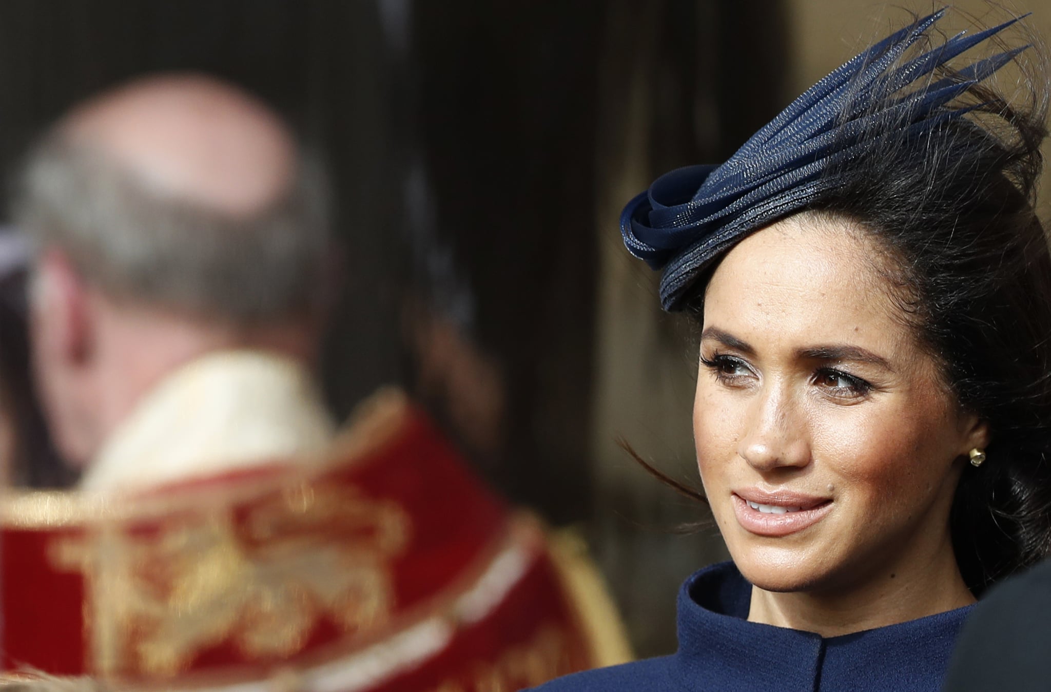 Britain's Meghan, Duchess of Sussex smiles as she waits for the carriage carrying Princess Eugenie of York and her husband Jack Brooksbank to pass at the start of the procession after Princess Eugenie and James Brookbank's wedding ceremony at St George's Chapel, Windsor Castle, in Windsor, on October 12, 2018. (Photo by Alastair Grant / POOL / AFP)        (Photo credit should read ALASTAIR GRANT/AFP/Getty Images)