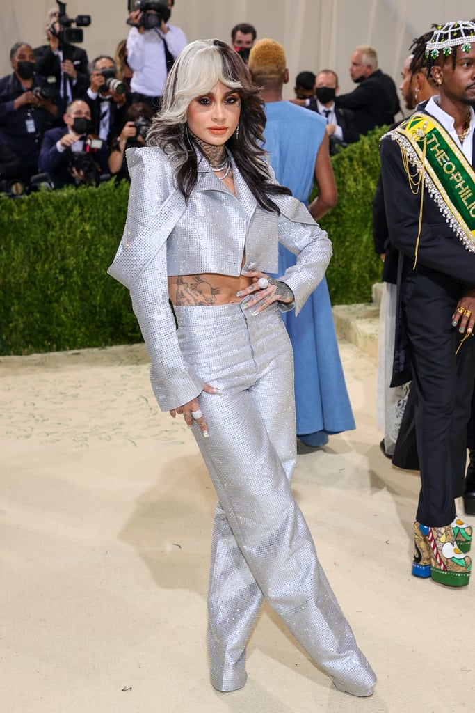 This year's American-themed Met Gala delivered dozens of unforgettable celebrity fashion moments, thanks in part to the style wisdom of Law Roach. A full day after the Costume Institute Benefit, we can't take our eyes off the crystal-embellished Aliétte suit he styled for Kehlani. Sparkling from every angle, the suit included a cropped jacket with exaggerated shoulder pads and high-waisted, wide-leg pants that stretched all the way to the floor. Styled with feathered waves, silver platform boots, a rainbow Hublot watch, and a whole jewelry store's worth of diamond rings, the crystal suit made Kehlani look like a '70s disco queen. 
A few hours later, the "I Like Dat" singer hit up the LaQuan Smith MET Gala afterparty in an Aliétte black pinstripe wool suit with flowers and symbols inspired by her personal tattoos — including the words "Come as You Are" — embroidered on the sleeves and Giuseppe Zanotti shoes. She paired the look with oversize hoop earrings and red heels that brought out the bright red roses clinging to her sleeves. Take in both of Kehlani's Met Gala-inspired outfits ahead, and check out Rihanna's diamonds on the red carpet here for even more bling.

    Related:

            
            
                                    
                            

            Natalia Bryant Couldn&apos;t Sit Down at the Met Gala, but That Gorgeous Dress Makes It All Worth It