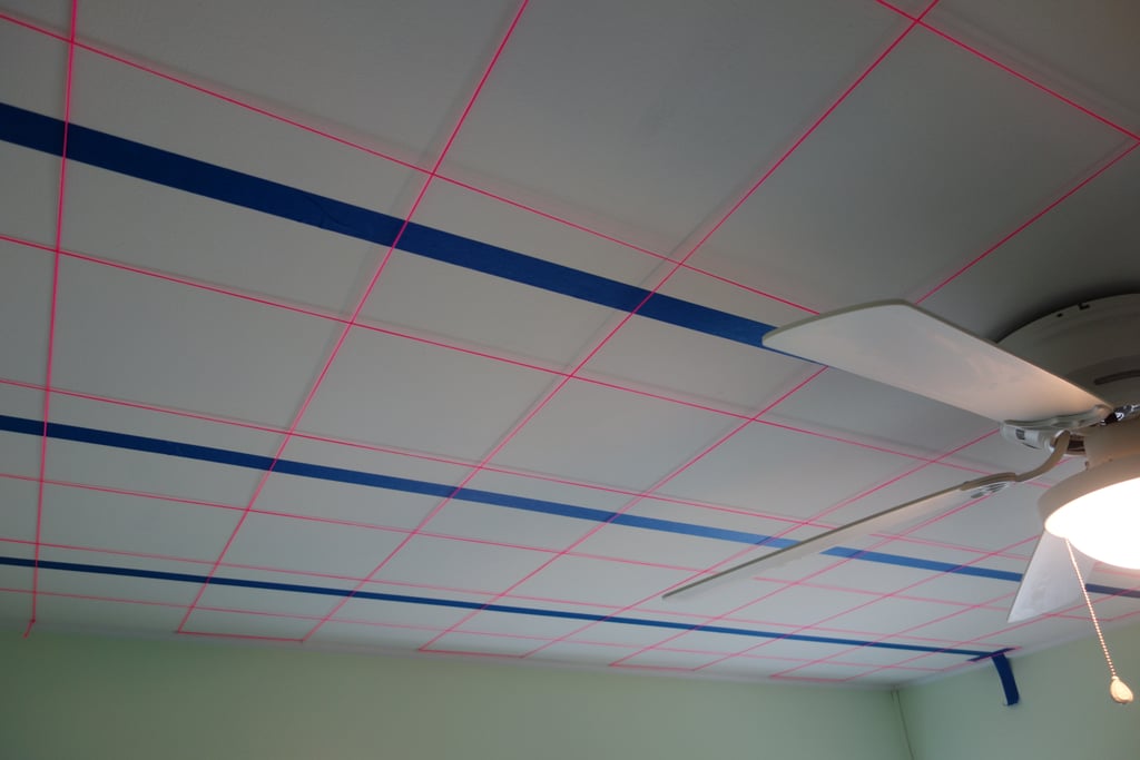 Using painter's tape and string, Brian created a ceiling grid to help him figure out where to drill holes. 
Source: Imgur user MRDRC