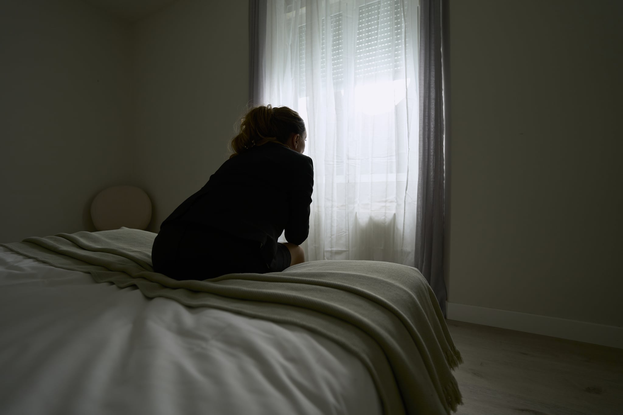 woman sitting on the edge of a bed