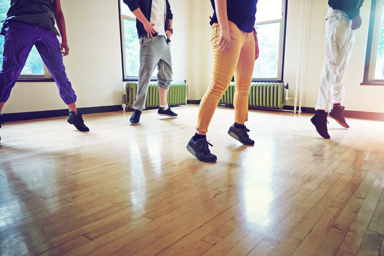Cropped shot of a group of people dancing together in a studio