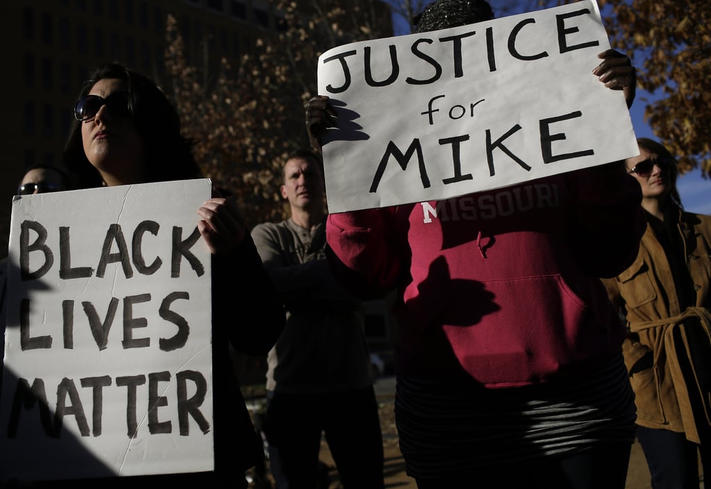 A protester held a "Justice for Mike" sign in Clayton, MO.
