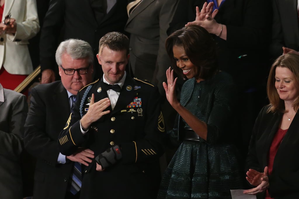 Michelle waved as she waited for her husband's speech.