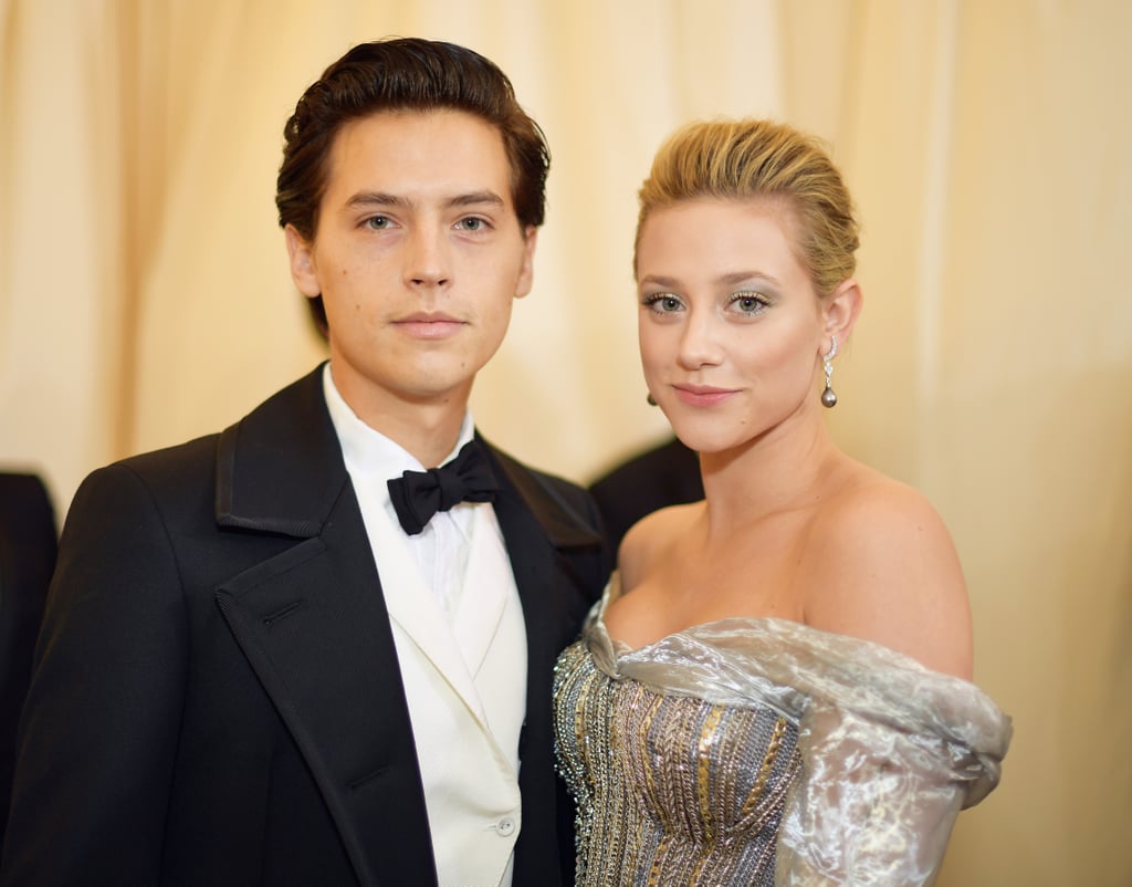 Cole Sprouse and Lili Reinhart have officially gone public with their romance! The Riverdale costars and longtime rumored couple attended the Met Gala together in NYC on Monday night, and we're dying over how cute they are. While Cole traded Jughead's crown beanie and Serpent jacket for slicked back hair and a fitted suit, Lili, who plays Betty on the hit CW series, looked absolutely gorgeous in a silver dress and matching eyeshadow. They even did a cute couple pose on the red carpet as Lili placed her hand on Cole's chest. Can you hear us screaming? Catch a glimpse of their adorable outing below and get ready to swoon big time.