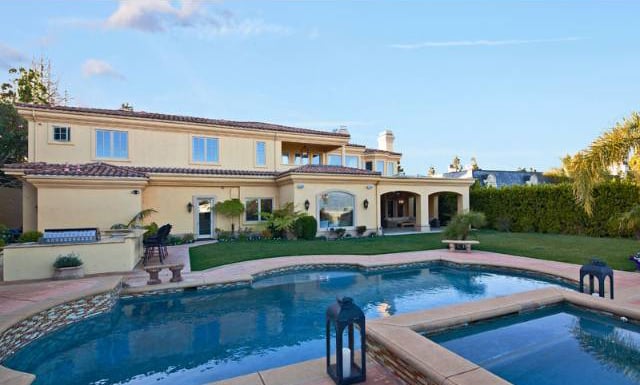 The backyard features a pool, a spa, and plenty of outdoor space.