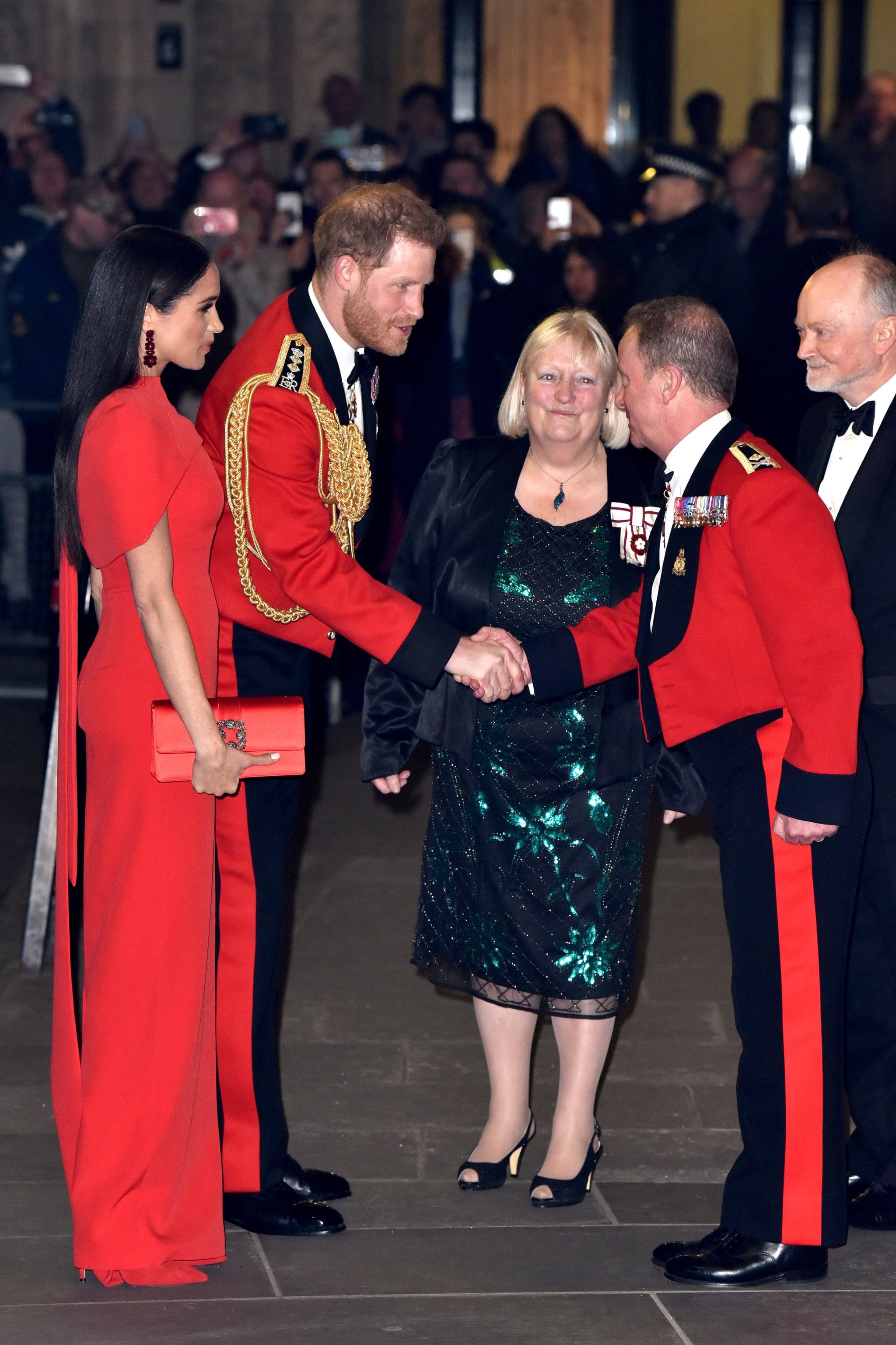 Meghan Markle At The Mountbatten Festival Of Music Meghan Markle Color Coordinates With Prince Harry In A Red Safiyaa Cape Dress Popsugar Fashion Photo 20