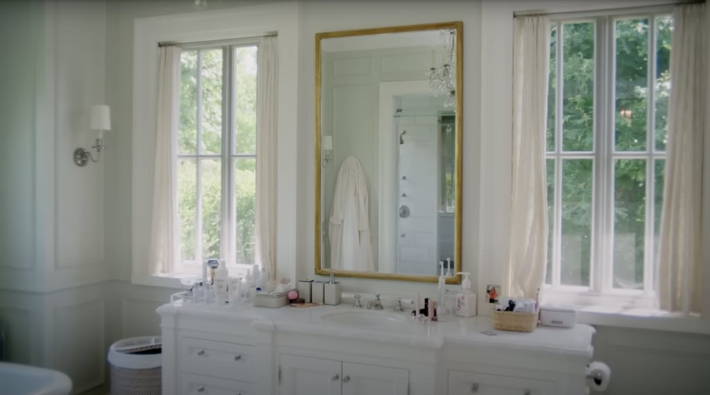 A classic gold-trimmed mirror makes the room feel even bigger, while two additional windows provide even more natural light for getting ready.