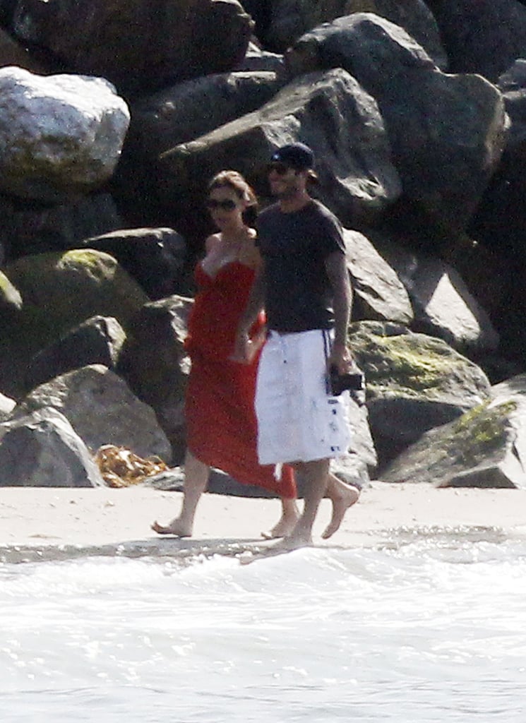 They walked arm in arm on the beach in Malibu in July 2011.