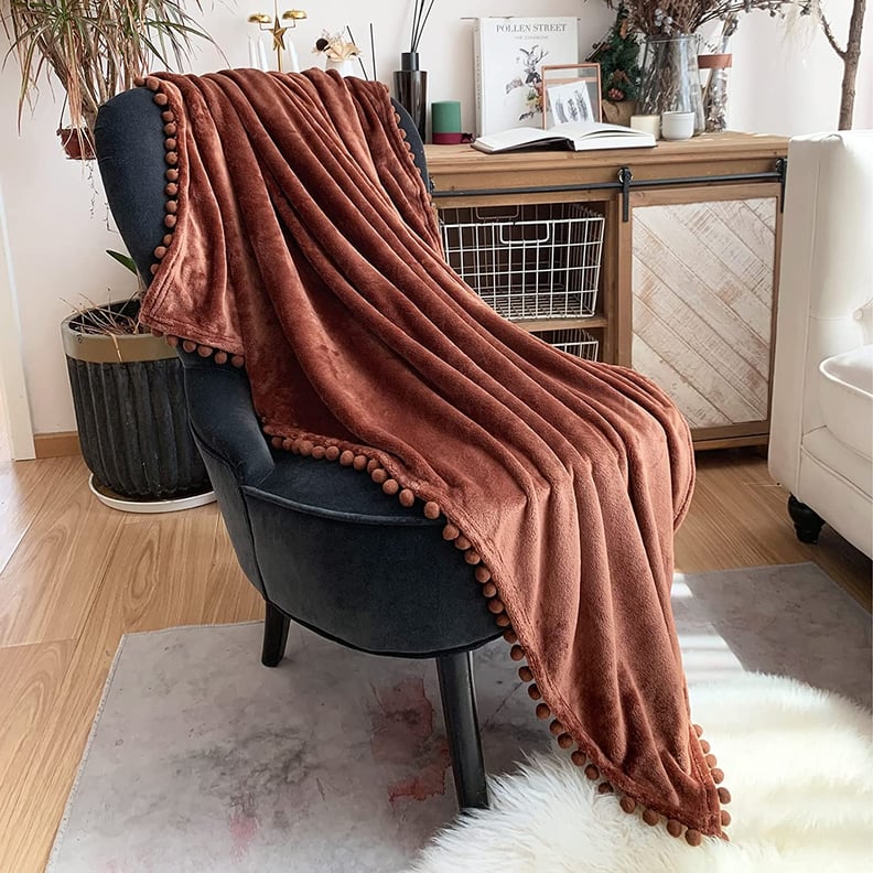 For Cozy Fall Vibes: Lomao Flannel Blanket With Pompom Fringe