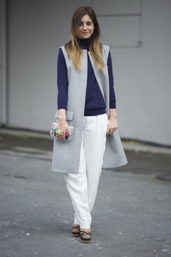 Layering is the best (and chicest) way to stay warm in the cooler months. Wear a vest effortlessly over loose white trousers and a navy turtleneck.