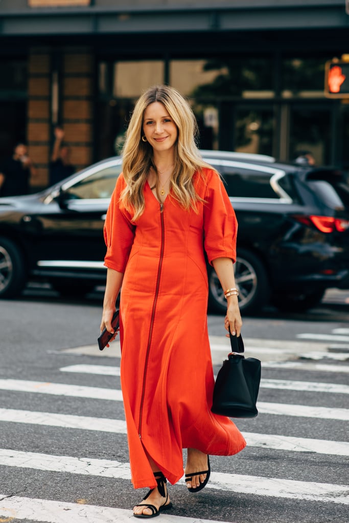 When you're wearing a bright color, like tomato red, complete your dress with minimal accessories.