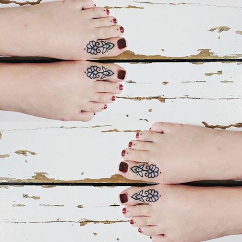 Matching illustrative flower tattoo on the feet