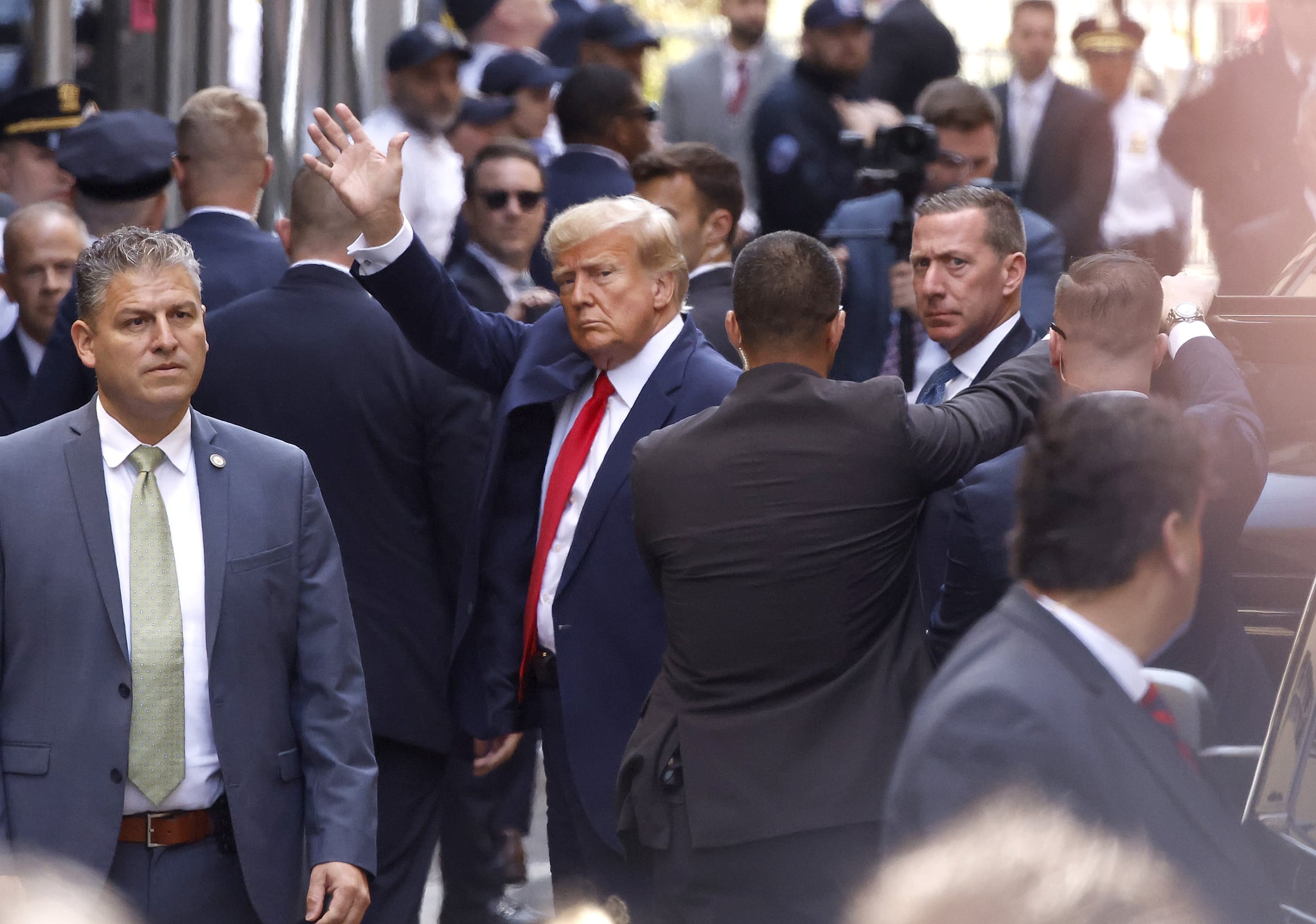 NEW YORK, NEW YORK - APRIL 04: Former U.S. President Donald Trump waves as he arrives at the Manhattan Criminal Court on April 04, 2023 in New York, New York.  Trump will be arraigned during his first court appearance today following an indictment by a grand jury that heard evidence about money paid to adult film star Stormy Daniels before the 2016 presidential election. With the indictment, Trump becomes the first former U.S. president in history to be charged with a criminal offence. (Photo by Kena Betancur/Getty Images)