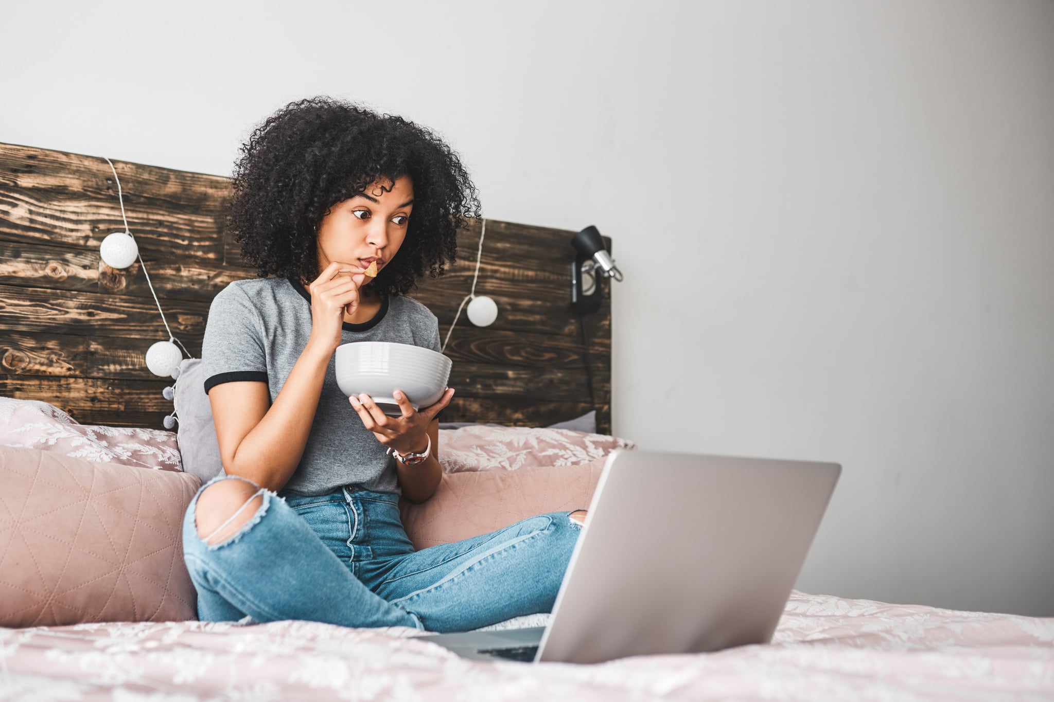 Shot of a young woman using a laptop while sitting in her bedroom