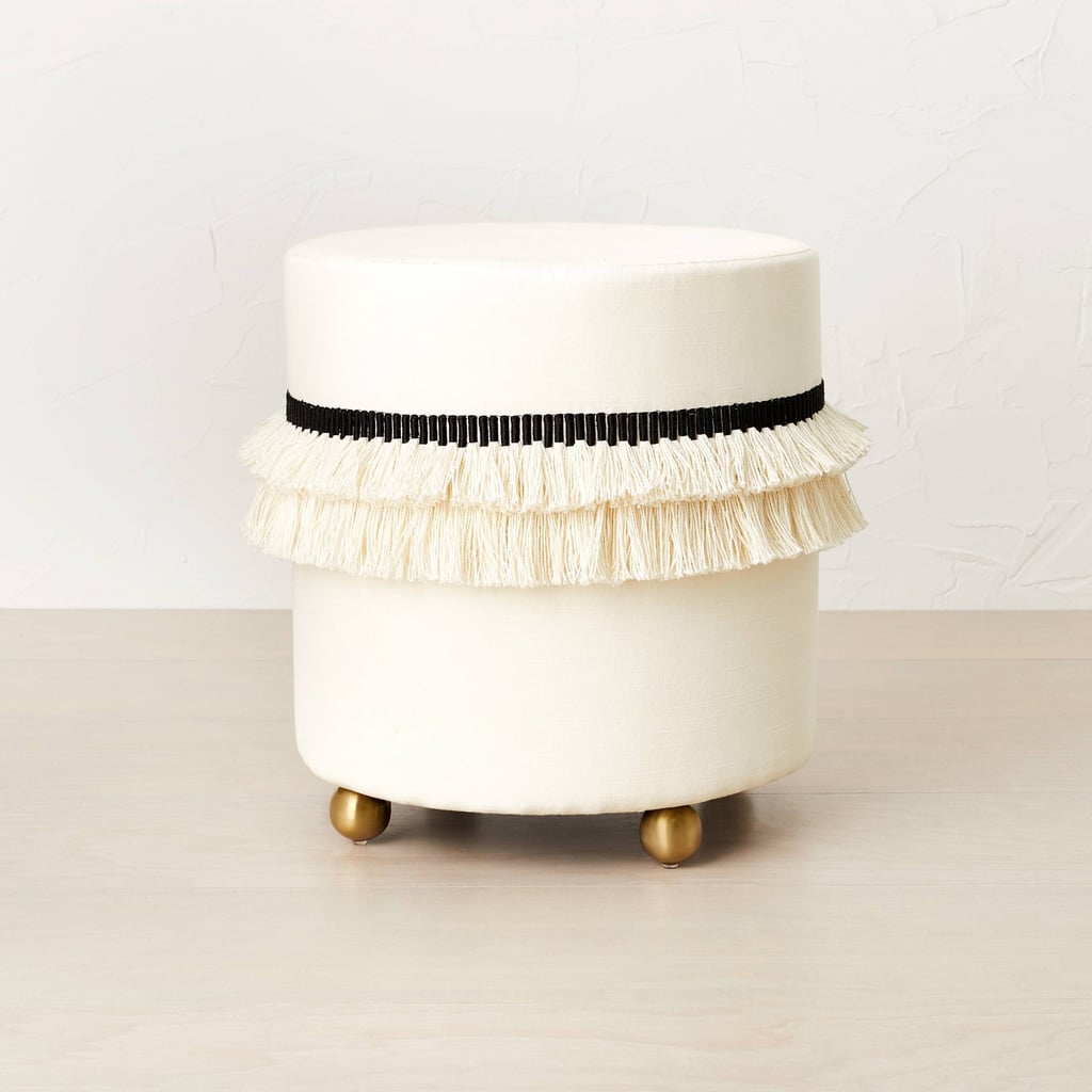 A Glam Ottoman Opalhouse designed with Jungalow Catania Tassel Ottoman with Ball Feet