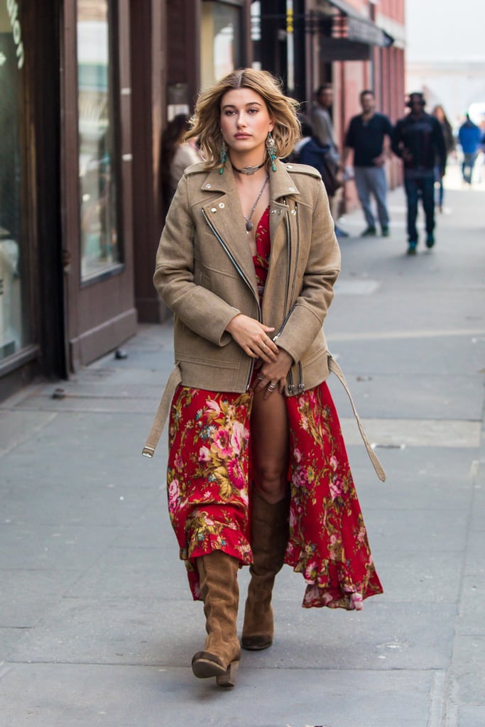 Hailey Baldwin made a quick change into a floral, ruffle-finished red dress with a deep plunging neckline and thigh-high slit. She gave off serious '70s vibes in tan suede knee-high boots and a crisply tailored, oversize moto jacket.