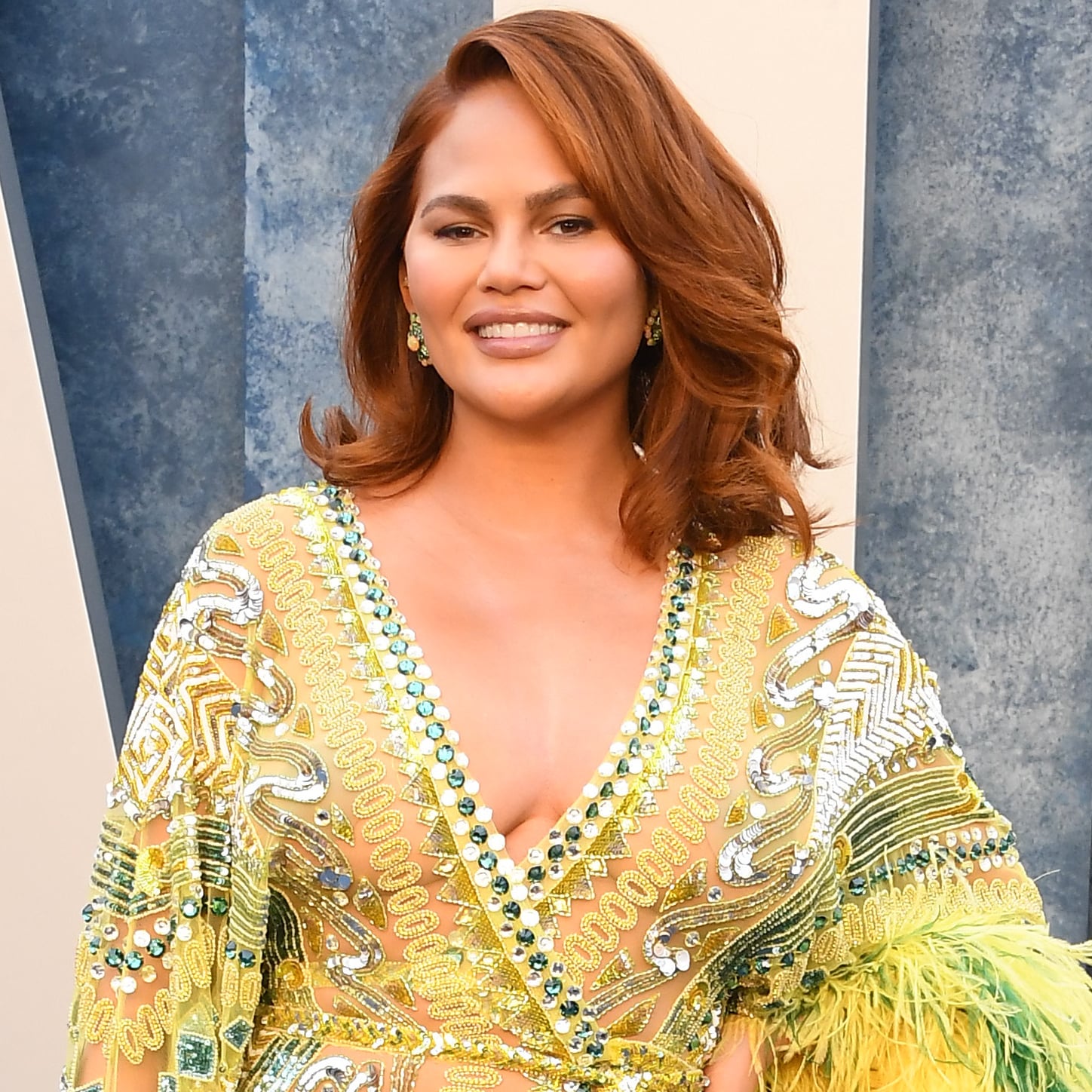 Chrissy Teigen happily flashes her lace bra in racy sheer top as