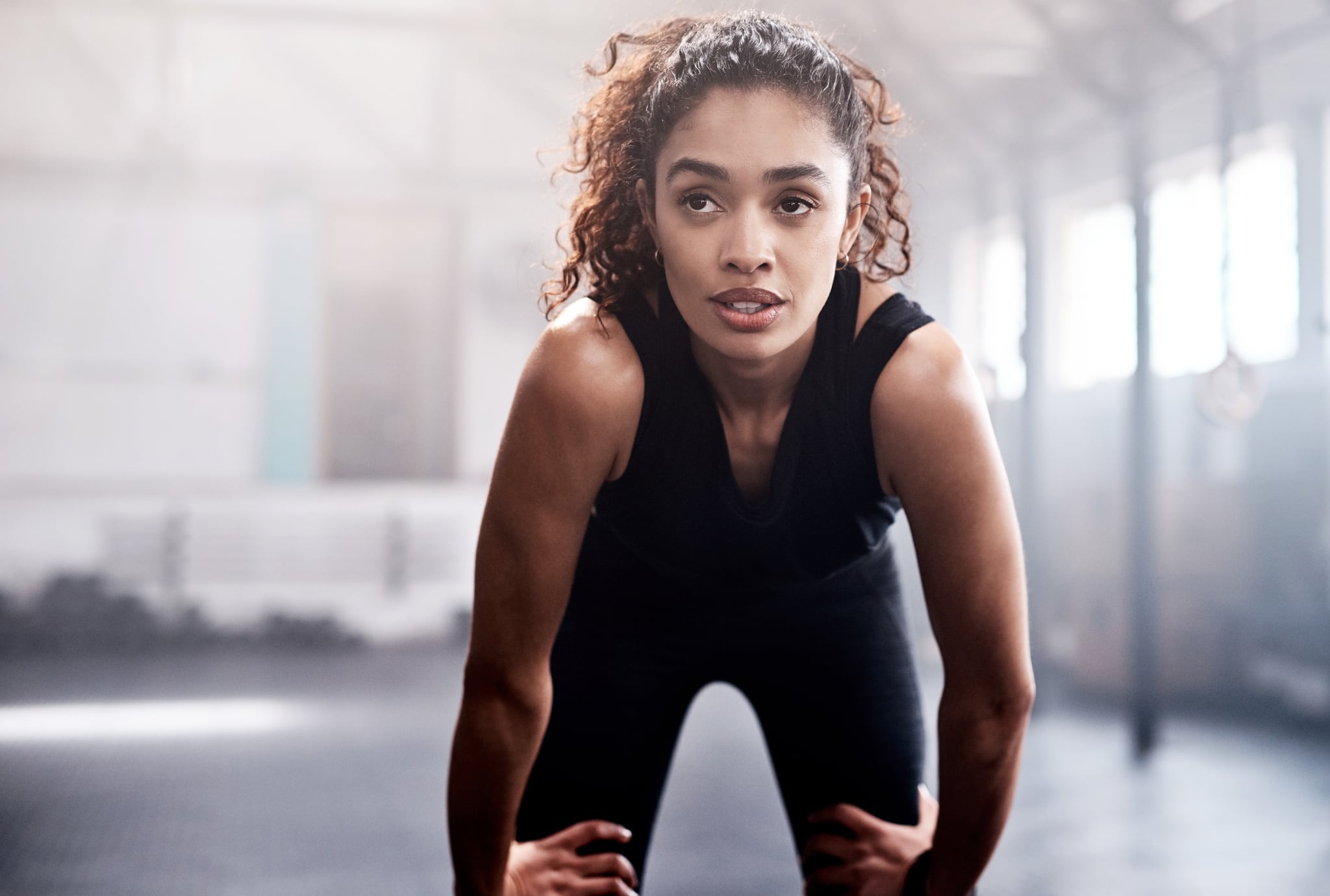 Cropped shot of an attractive and athletic young woman looking tired after a workout in the gym