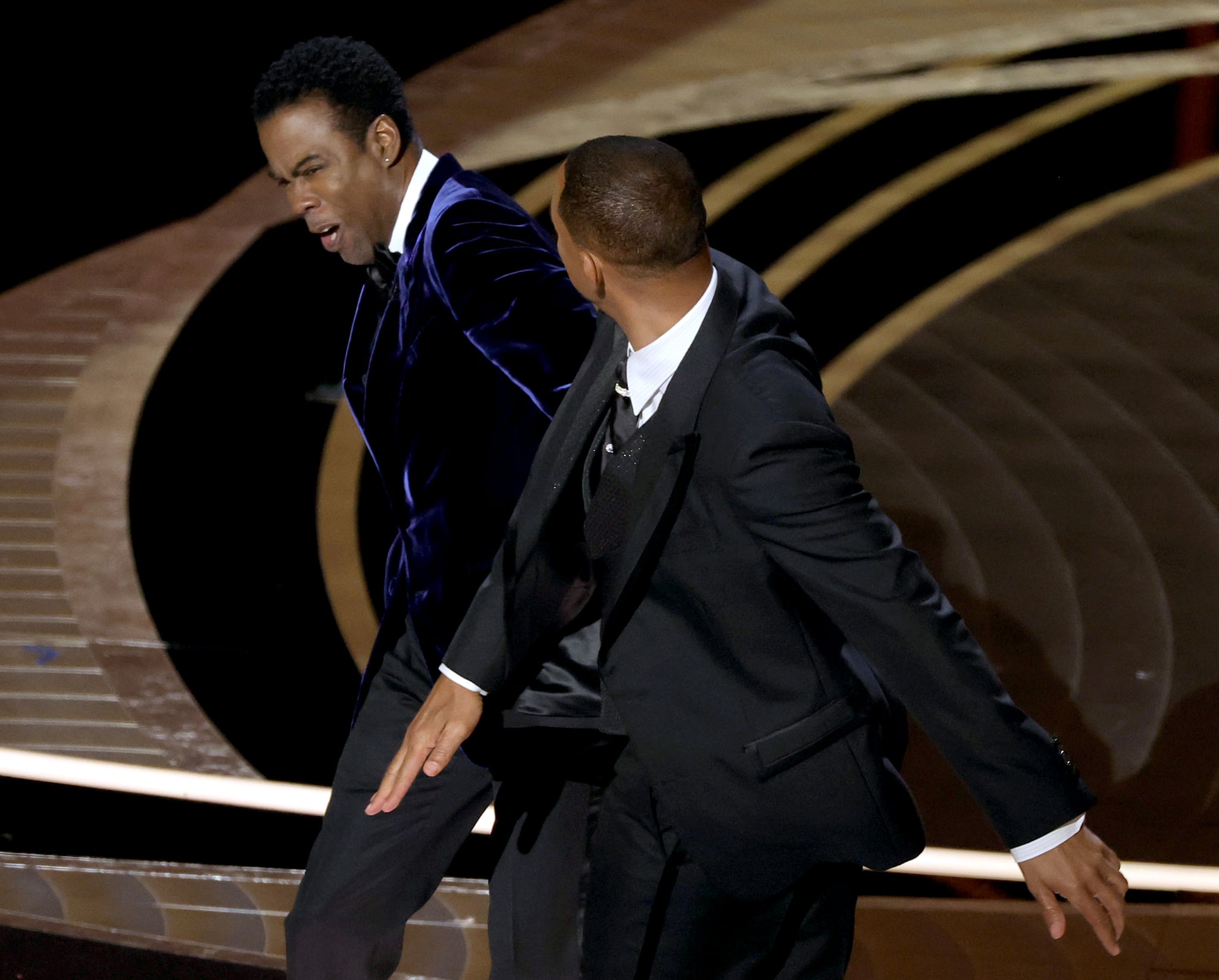 HOLLYWOOD, CALIFORNIA - MARCH 27: (L-R) Chris Rock and Will Smith are seen onstage during the 94th Annual Academy Awards at Dolby Theatre on March 27, 2022 in Hollywood, California. (Photo by Neilson Barnard/Getty Images)