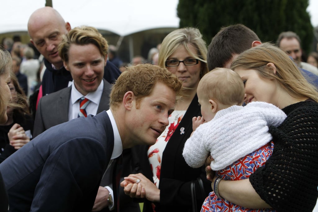 Prince Harry Coos over adorable Babies.