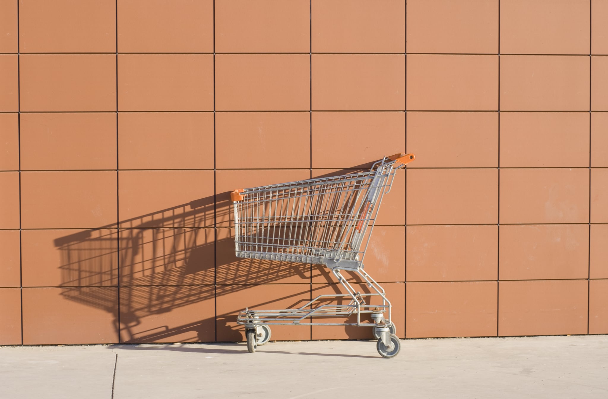 a shopping cart in front of the outside of a store